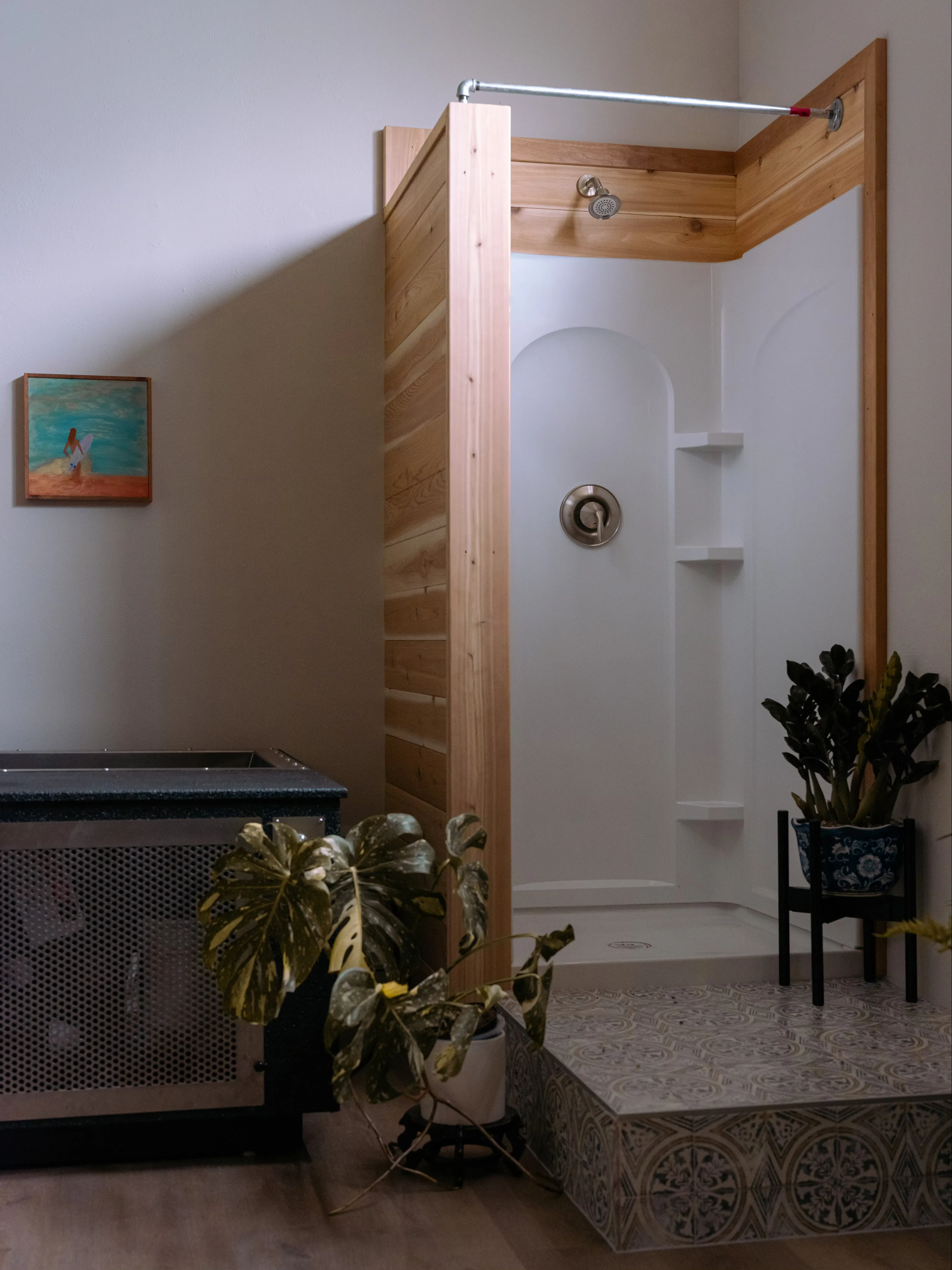 A cedar-framed private shower beside the cold plunge